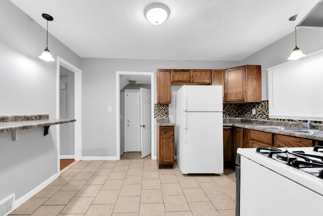 kitchen featuring decorative backsplash, light tile patterned floors, pendant lighting, and white appliances