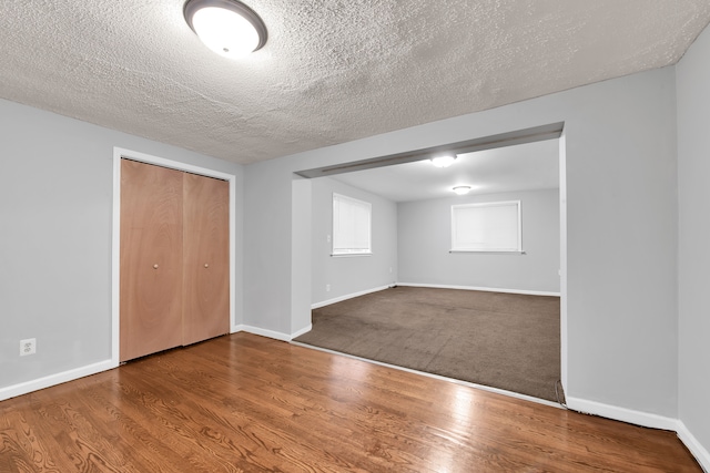 interior space featuring wood-type flooring and a textured ceiling