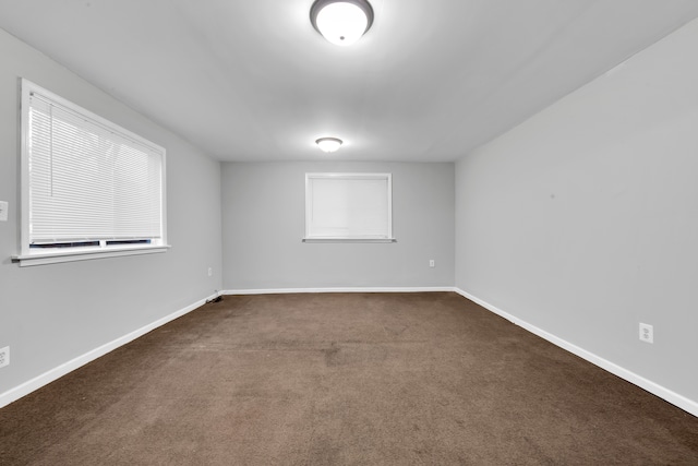 empty room with dark carpet