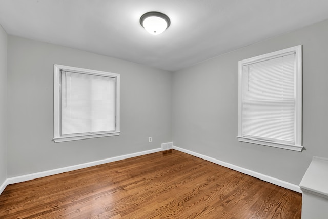 empty room with hardwood / wood-style floors