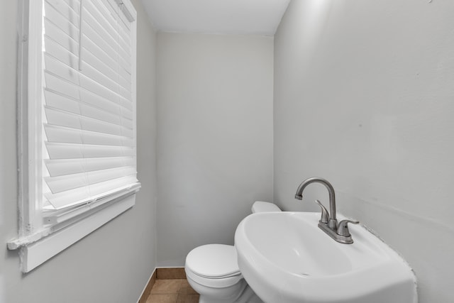 bathroom with tile patterned flooring, toilet, and sink