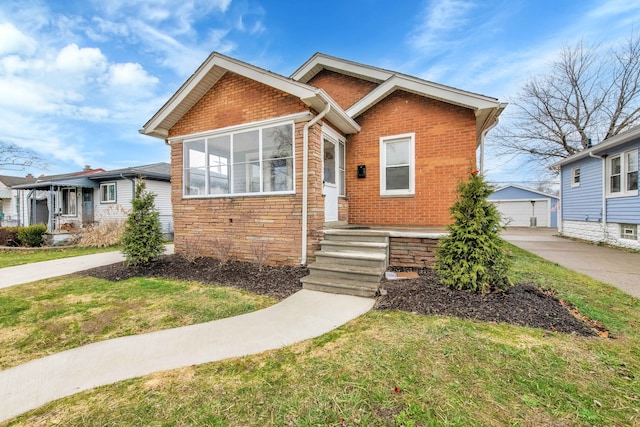 view of front of house with an outbuilding, a front yard, and a garage