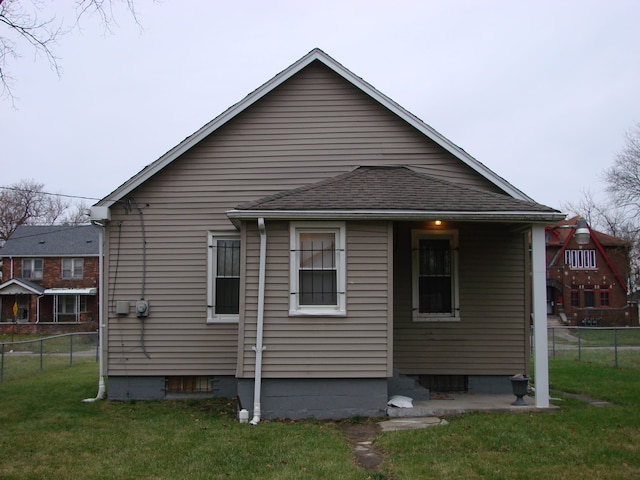 rear view of property with a lawn