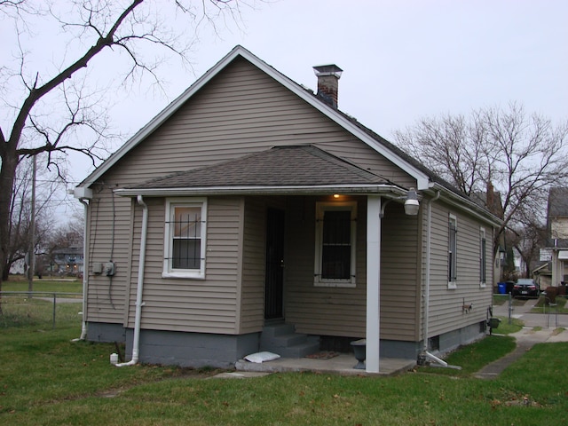 back of property with a lawn