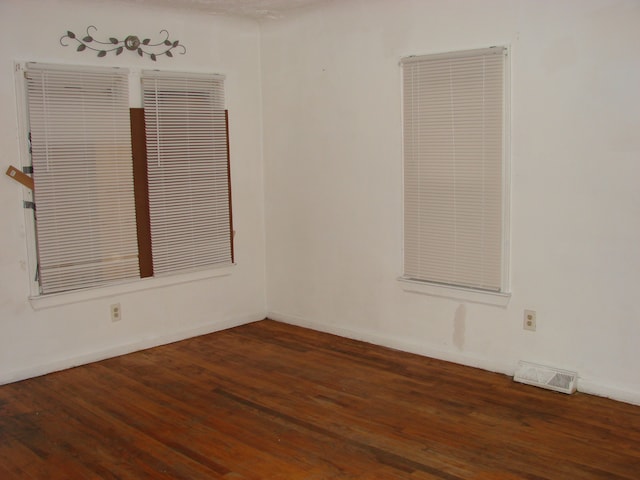 spare room featuring dark hardwood / wood-style flooring