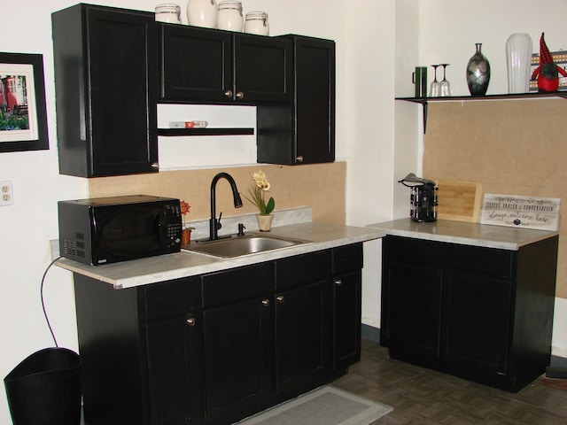 kitchen featuring parquet flooring and sink