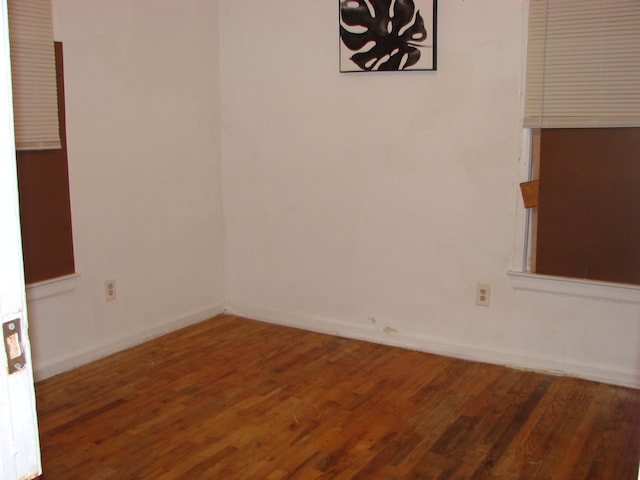 spare room with dark hardwood / wood-style flooring