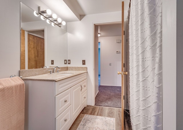 bathroom with vanity and wood-type flooring