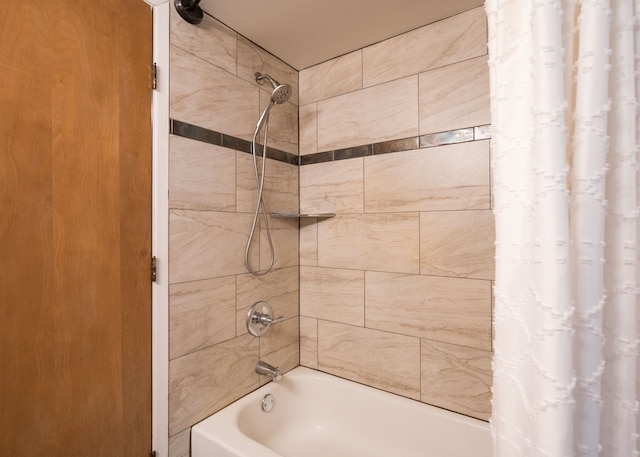 bathroom with shower / bath combination with curtain