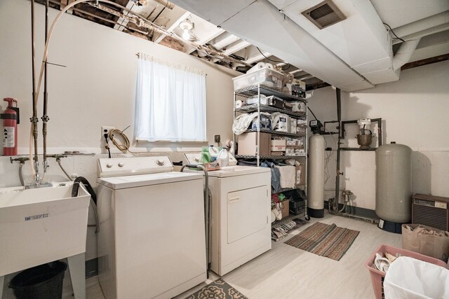 washroom with washing machine and clothes dryer and sink