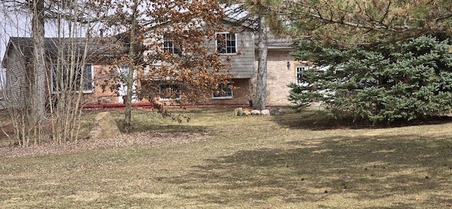 12070 Rattalee Lake Rd, Davisburg, MI 48350 - rear view of property featuring brick siding and a yard