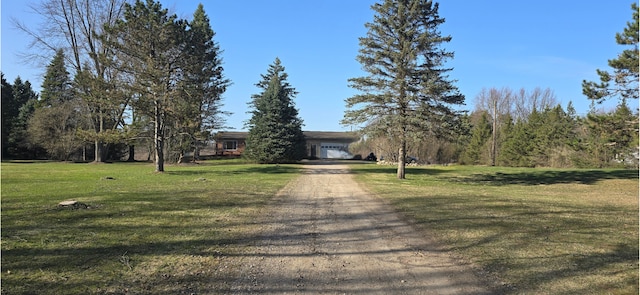 12070 Rattalee Lake Rd, Davisburg, MI 48350 - view of front facade featuring dirt driveway, a front lawn, and a garage