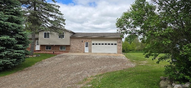 12070 Rattalee Lake Rd, Davisburg, MI 48350 - split level home featuring driveway, brick siding, an attached garage, and a front yard