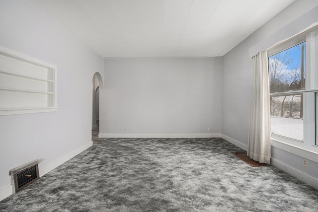 928 Phoenix St, South Haven, MI 49090 - spare room with carpet, arched walkways, and baseboards