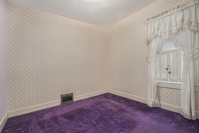 928 Phoenix St, South Haven, MI 49090 - empty room with wallpapered walls, dark colored carpet, and baseboards