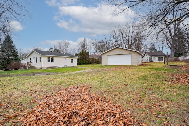 view of yard featuring an outbuilding and a garage