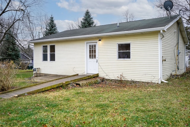 rear view of property featuring a yard and a wooden deck