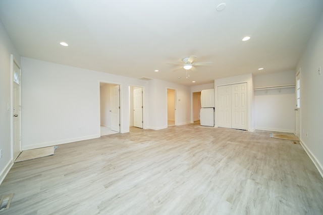 interior space featuring white refrigerator, light hardwood / wood-style floors, and ceiling fan