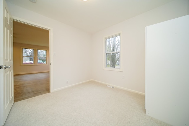 unfurnished room with light hardwood / wood-style floors and a wealth of natural light