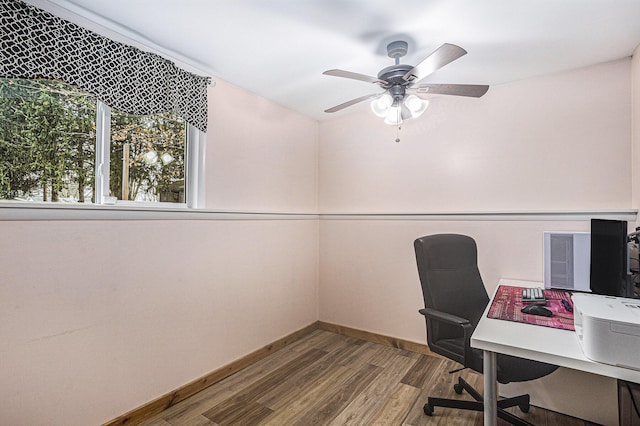 office area featuring a ceiling fan, baseboards, and wood finished floors