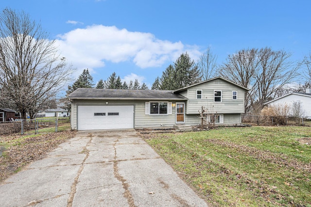 tri-level home featuring a front yard and a garage