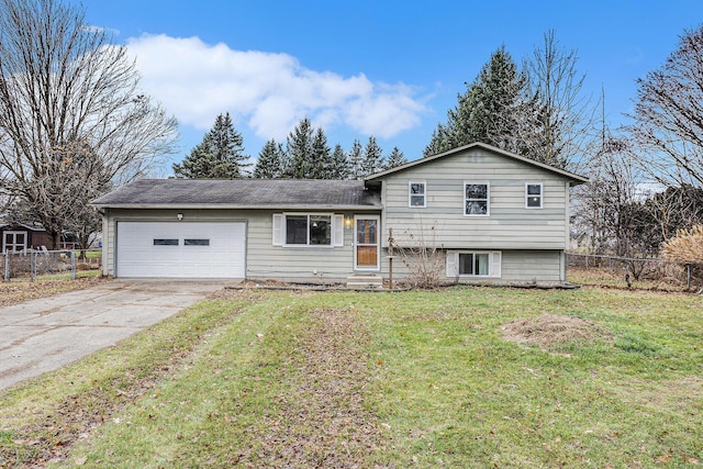 split level home with a front lawn and a garage