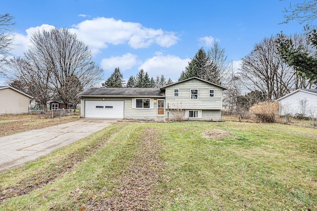 tri-level home featuring a garage and a front lawn