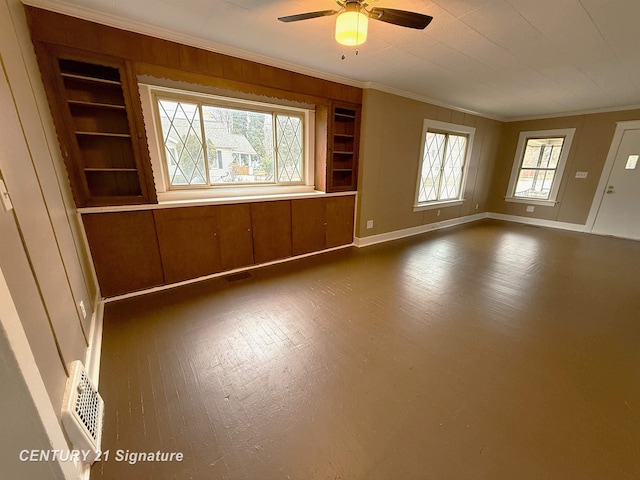 unfurnished living room featuring hardwood / wood-style floors, ceiling fan, built in features, and crown molding