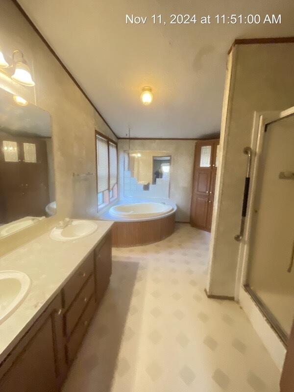 bathroom featuring vanity, lofted ceiling, and shower with separate bathtub