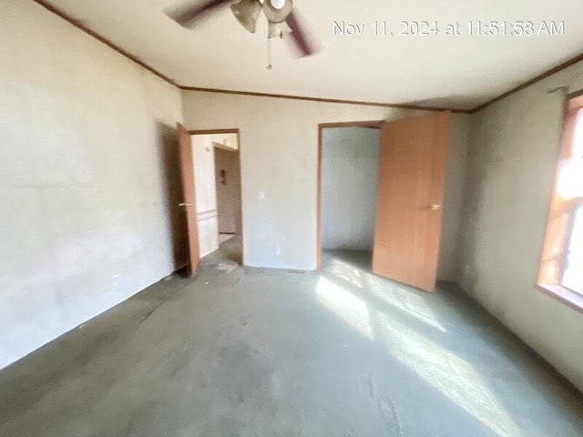 unfurnished bedroom with ceiling fan and concrete floors