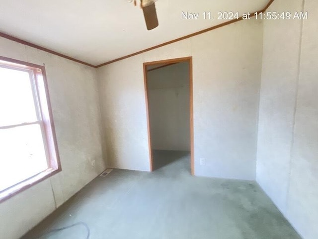 unfurnished room with ceiling fan, crown molding, and vaulted ceiling