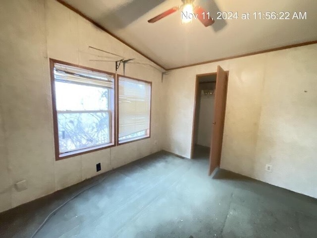 unfurnished room with ceiling fan and vaulted ceiling