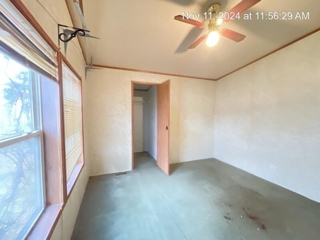 spare room with ceiling fan and concrete flooring