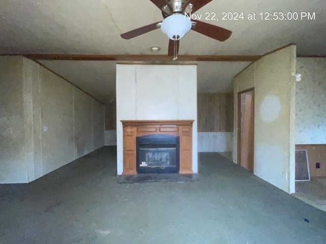 unfurnished living room with ceiling fan and concrete floors