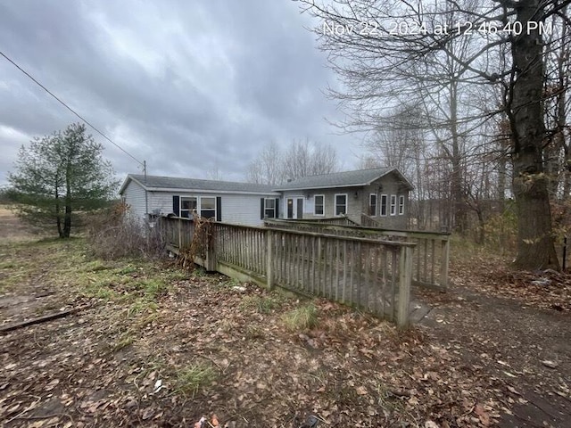 rear view of house with a wooden deck