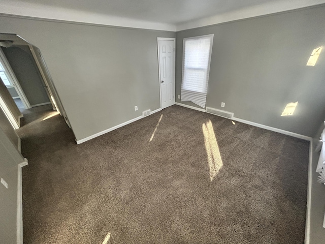 empty room with dark carpet