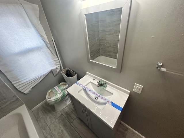 bathroom featuring vanity and toilet