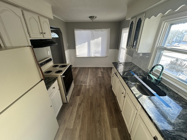 kitchen featuring dark wood-type flooring, sink, dark stone countertops, white appliances, and white cabinets