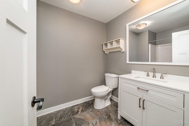 bathroom featuring a shower, vanity, and toilet