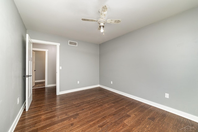 empty room with ceiling fan and dark wood-type flooring