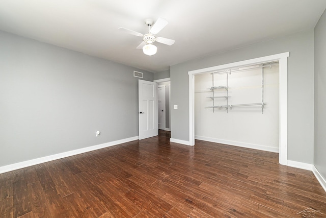 unfurnished bedroom featuring ceiling fan, a closet, and dark hardwood / wood-style floors