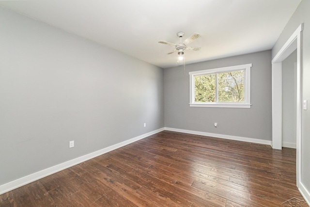 unfurnished room featuring dark hardwood / wood-style floors and ceiling fan