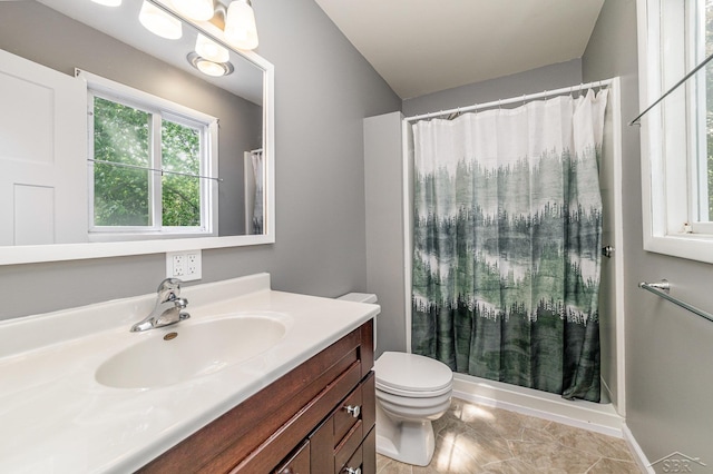 bathroom featuring tile patterned floors, vanity, toilet, and walk in shower