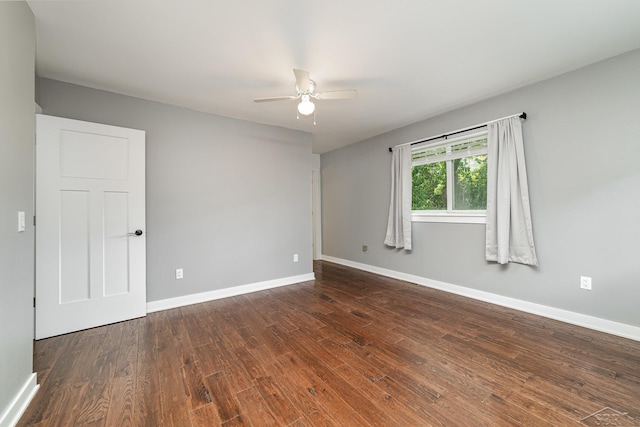 unfurnished room with dark hardwood / wood-style floors and ceiling fan