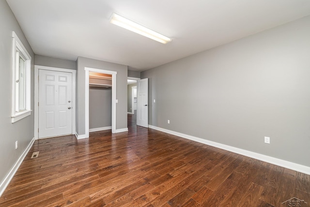 unfurnished bedroom with dark wood-type flooring