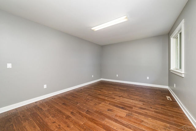 spare room featuring dark hardwood / wood-style flooring