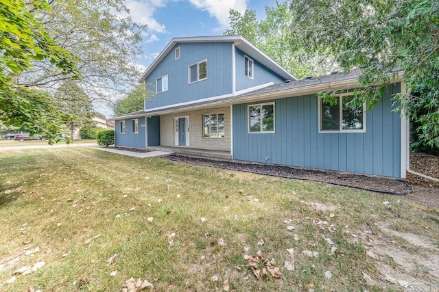 rear view of house with a yard