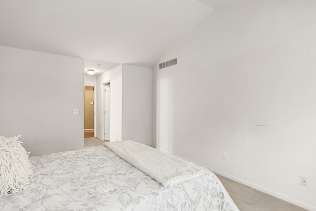 carpeted bedroom with vaulted ceiling