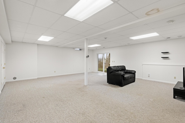 basement featuring a paneled ceiling and carpet floors