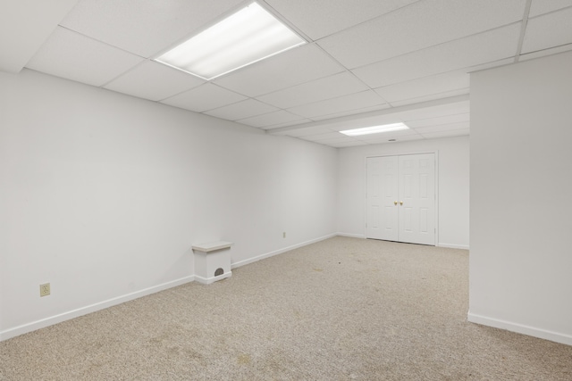 spare room with a paneled ceiling and carpet